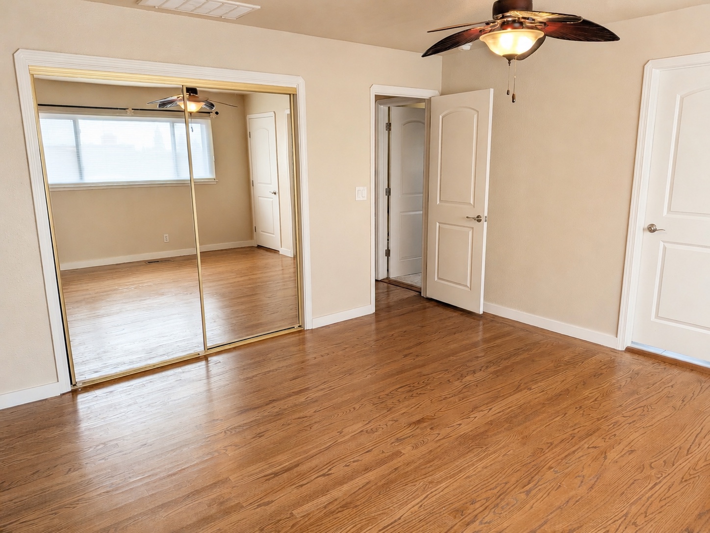 Primary bedroom with mirrored closets