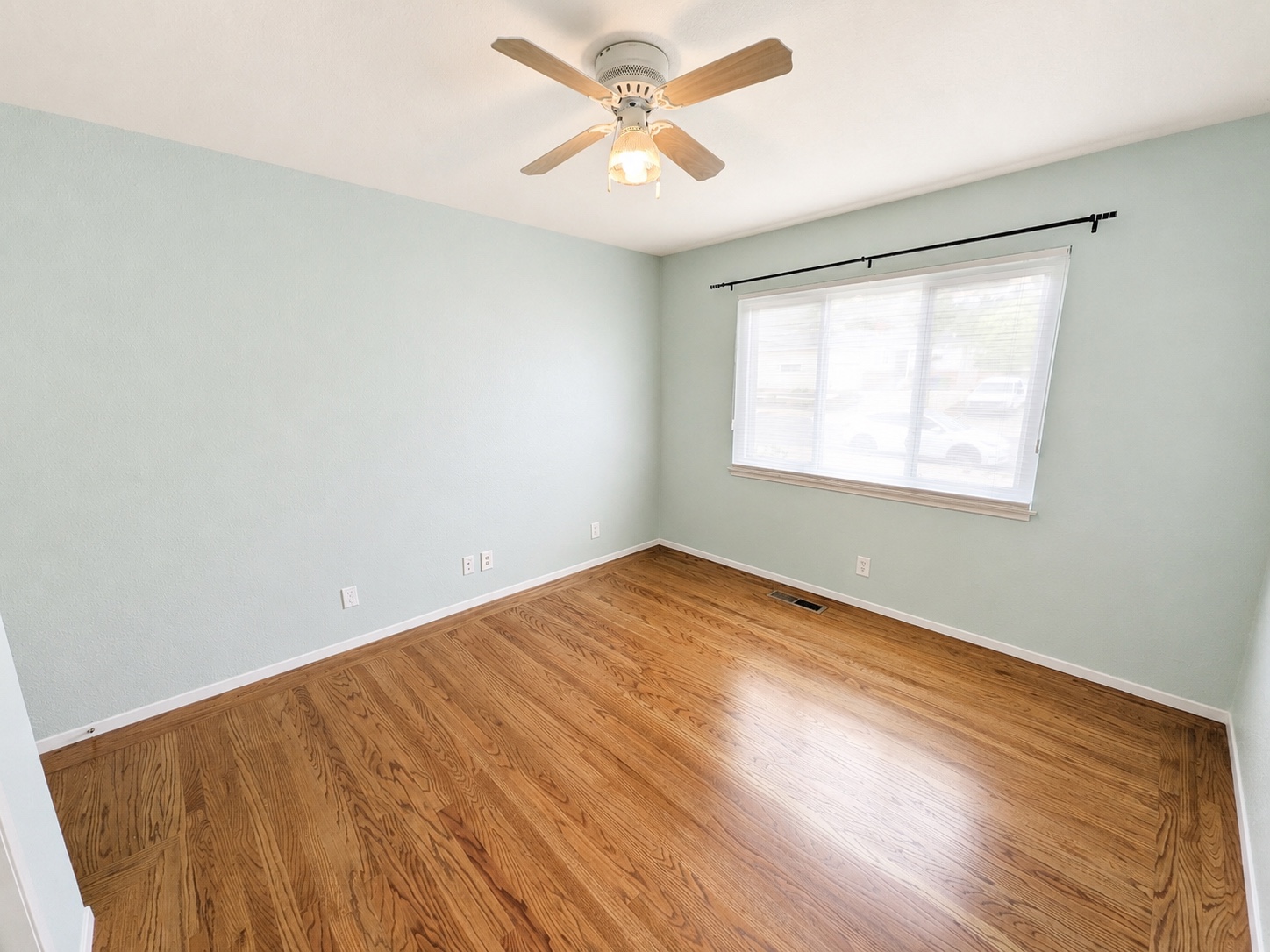 Sage bedroom with ceiling fan
