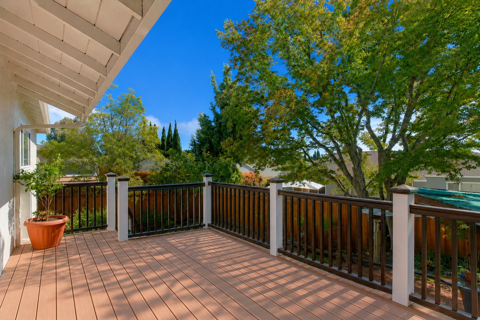 Deck lounge off the living room with tree-lined views